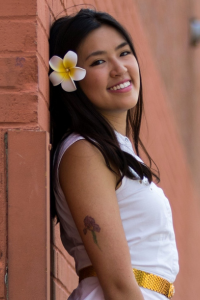 Sandra smiling with a flower in her hair
